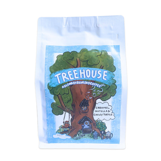 Treehouse-themed coffee package with a tree design and text on a blue background